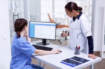 stomatolog-nurse-tooth-clinic-checking-patient-appointment-looking-computer-monitor-stomatology-assistant-teeth-doctor-discussing-reception-dental-office